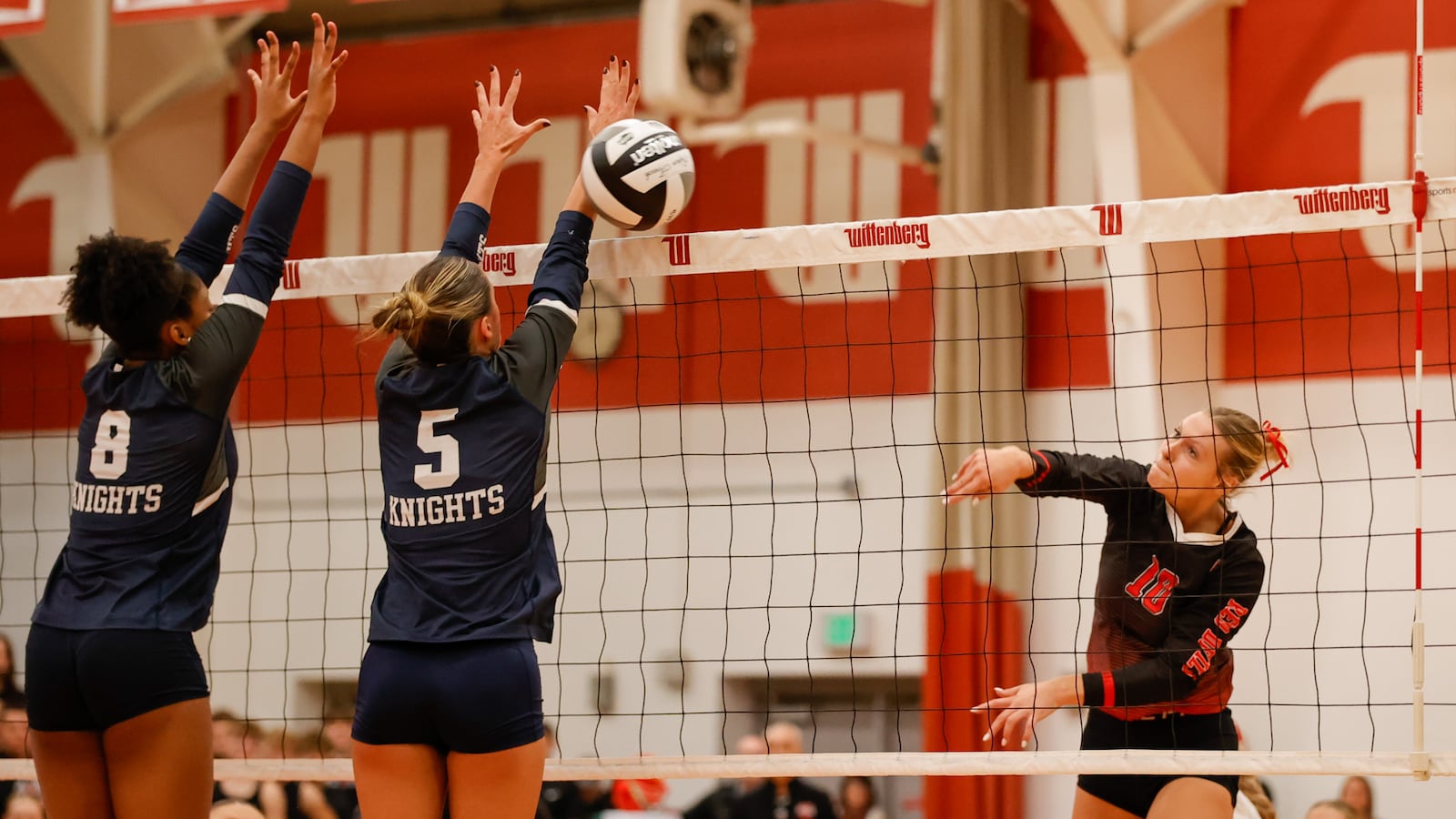 Tippecanoe High School senior Savannah Clawson hits the ball past Akron Hoban's Hope Sherman (8) and Madison Mintz (5) during their Division III state semifinal match on Friday, Nov. 7 at Wittenberg University's Pam Evans Smith Arena in Springfield. The Red Devils won 3-0. MICHAEL COOPER / STAFF PHOTO