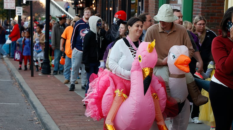 Hundreds of families came out Friday night, Oct. 28, 2022 for the thrid annual Downtown Trick or Treat event in Springfield. More than 20 businesses in the downtown area, along with community groups passed out candy and goodie bags along Fountain Avenue. BILL LACKEY/STAFF