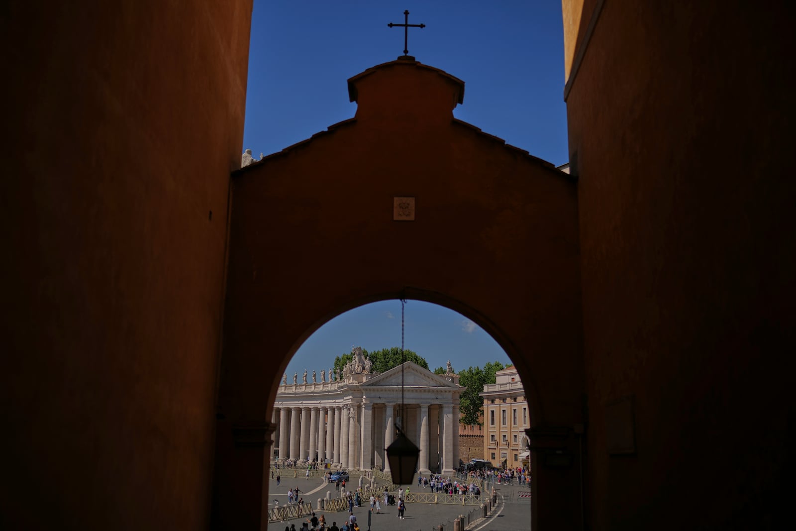FILE - The faithful and tourists walk along St Peter's square on the sixth day of mourning for late Pope Francis at the Vatican on Thursday, May 1, 2025. (AP Photo/Francisco Seco, File)