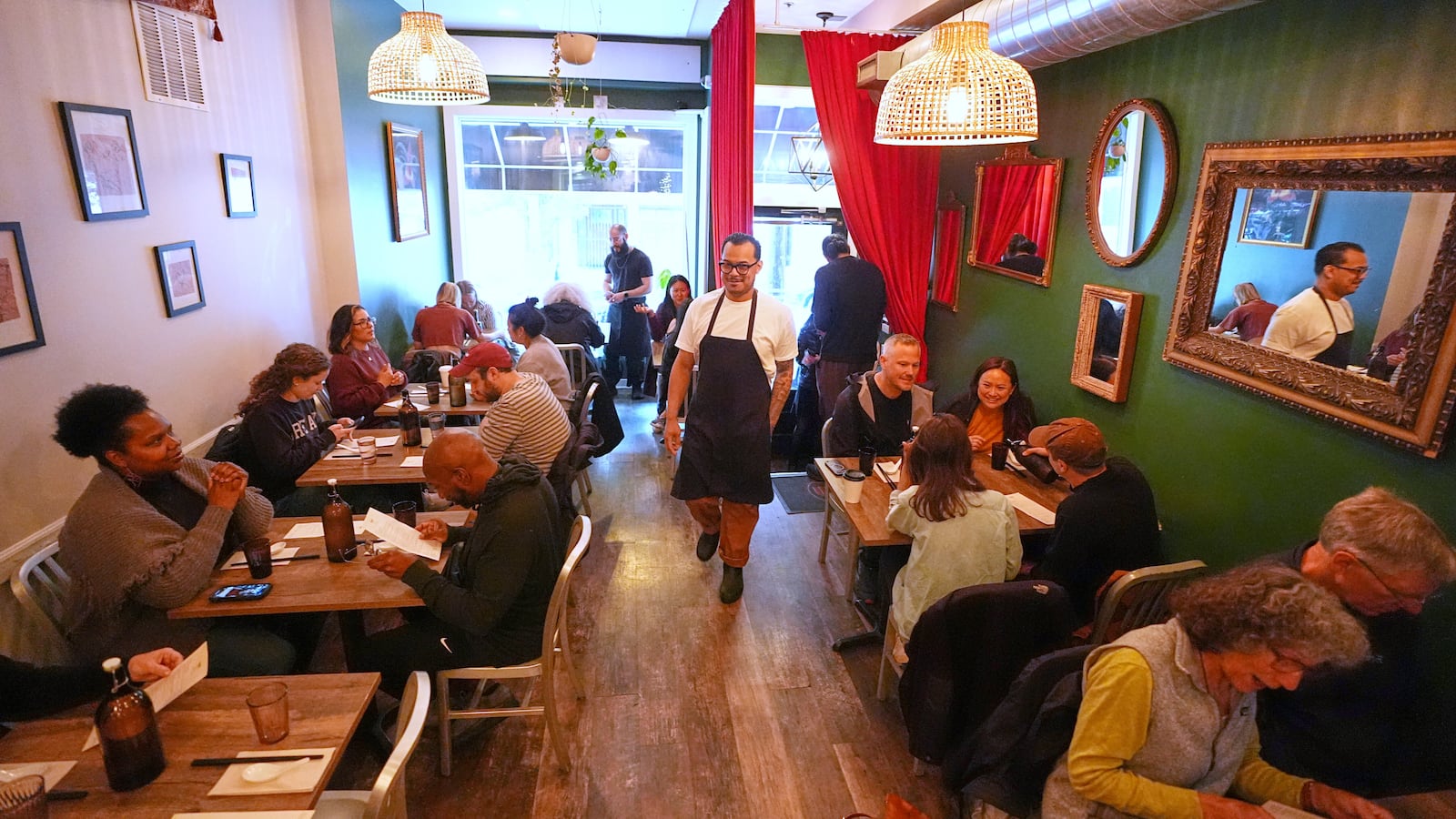 Chef Phila Lorn walks through his restaurant, Mawn, after opening for the day in Philadelphia, Thursday, May 22, 2025. (AP Photo/Matt Rourke)