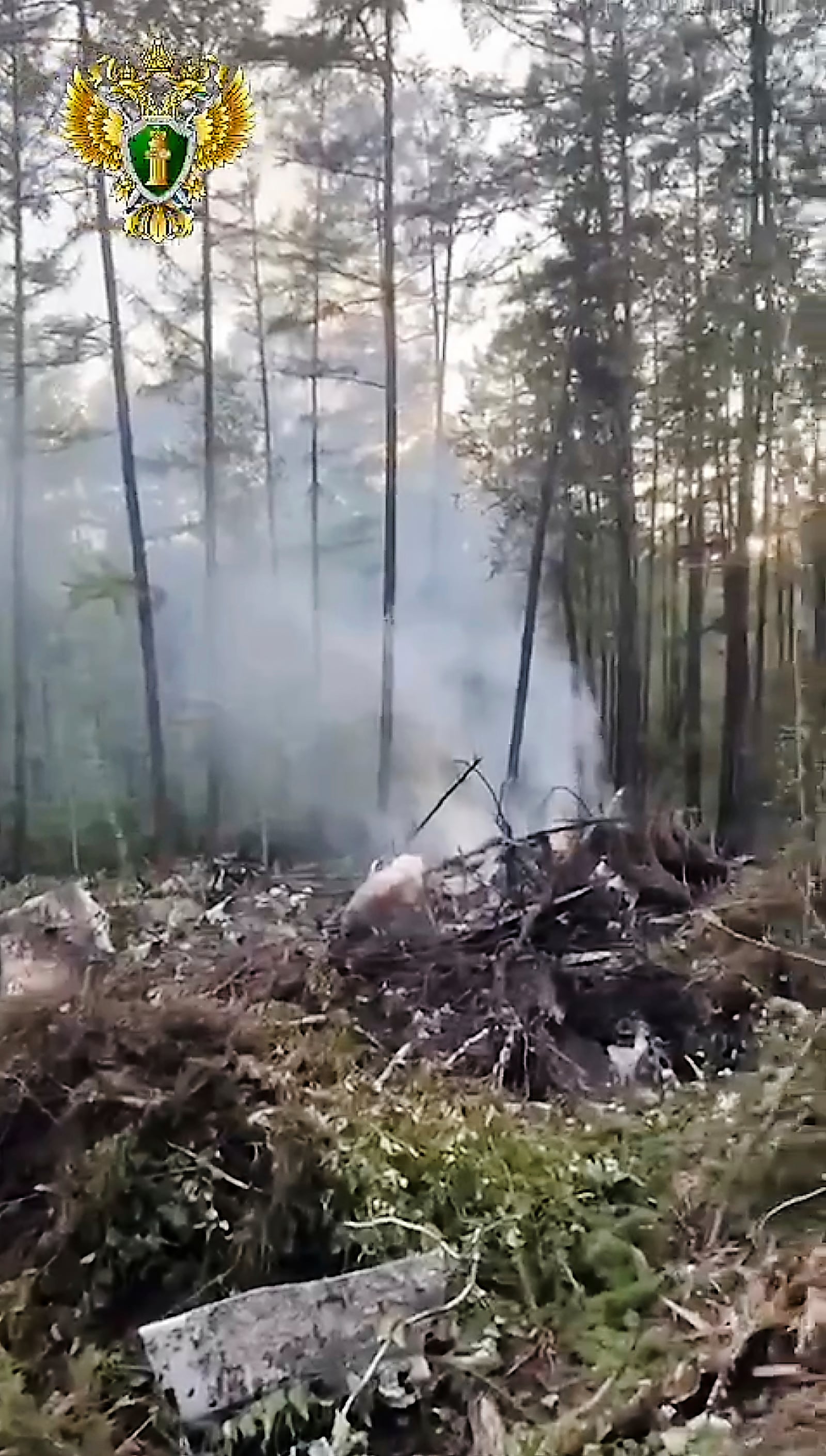 In this photo taken from video released by Russian Far Eastern Transport Prosecutor's Office on Thursday, July 24, 2025, a view of the place of the crashed Russian An-24 passenger plane of the Siberia-based Angara Airlines while carrying 49 passengers in 15 kilometers (9 miles) south of Tynda, Far Eastern Amur region of Russia. (Russian Far Eastern Transport Prosecutor's Office via AP)