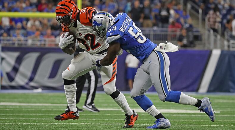 DETROIT, MI - AUGUST 18: Jeremy Hill #32 of the Cincinnati Bengals makes the catch for a short gain as Tahir Whitehead #59 of the Detroit Lions makes the stop during the first quarter of the preseason game at Ford Field on August 18, 2016 in Detroit, Michigan. (Photo by Leon Halip/Getty Images)