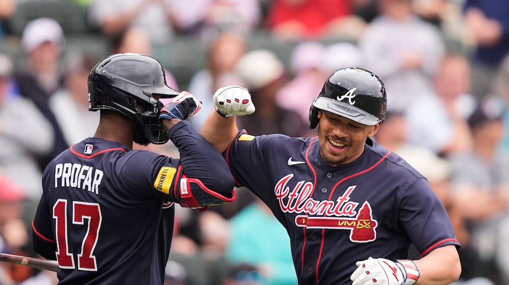 Atlanta Braves Drake Baldwin is greeted by Jurickson Profar after hitting a solo home run in the third inning of a spring training baseball game against the Minnesota Twins in North Port, Fla., Sunday, Feb. 22, 2026. (AP Photo/Gerald Herbert)