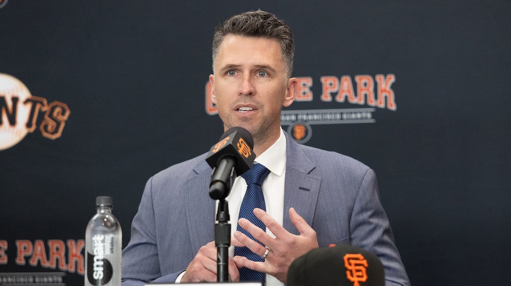 FILE -San Francisco Giants President of Baseball Operations Buster Posey sits during a press conference introducing Tony Vitello as the new manager of the San Francisco Giants baseball team on Oct. 30, 2025, in San Francisco. (AP Photo/Benjamin Fanjoy, File)