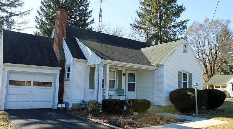 Exterior features of this 1.5-story home include a covered front porch and an attached garage. CONTRIBUTED PHOTOS BY VICKIE KAPNAS