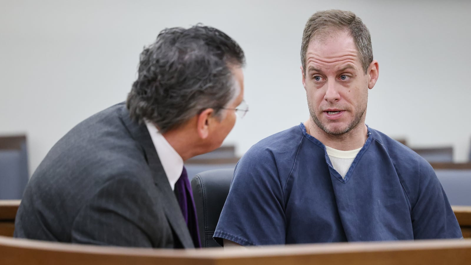 Caleb Flynn (right) talks to his attorney L. Patrick Mulligan during an arraignment on Thursday, March 19 at Miami County Common Pleas Court in Troy. Flynn's bond was increased to $3.5 million from the $2 million bond set in Miami County Municipal Court. He was arraigned Thursday following his indictment by a county grand jury Wednesday on 11 counts, including aggravated murder in the Feb. 16 death of his wife, Ashley. BRYANT BILLING / STAFF