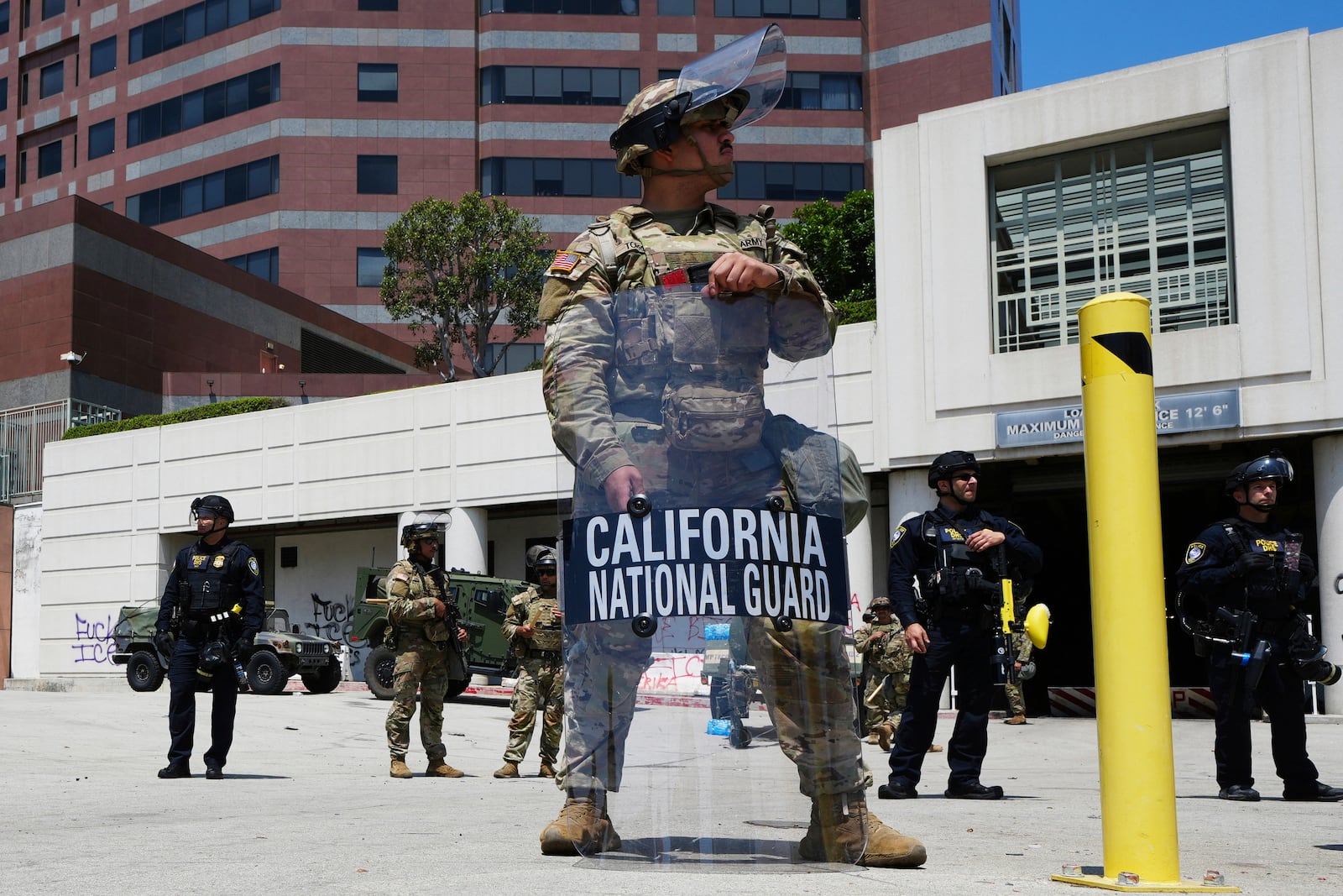 FILE - A California National Guardsmen stands to protect federal buildings, June 10, 2025, in Los Angeles. (AP Photo Damian Dovarganes, File)