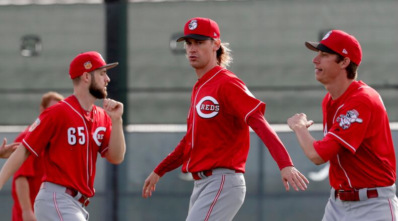 Cincinnati Reds’ Bronson Arroyo, center, stretches during the teams’ first day of spring training baseball workouts, Tuesday, Feb. 14, 2017 in Goodyear, Ariz. (AP Photo/Matt York)