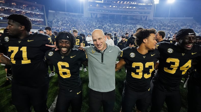 Vanderbilt head coach Clark Lea, center, celebrates the team's win with players after an NCAA college football game against Kentucky, Saturday, Nov. 22, 2025, in Nashville, Tenn. (AP Photo/George Walker IV)