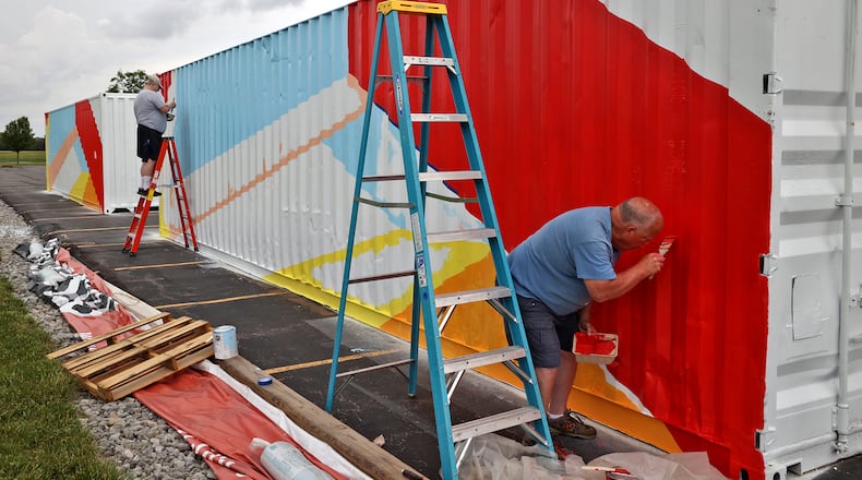 Volunteers Mike Ambuske (left) and Tom McGeean paint shipping containers in the parking lot of the First Christian Church. First Christian Church is partnering with Lifeline Christian Mission for the annual "Birthday Gift to Jesus" outreach program to send food and supplies to Honduras. The 40-foot containers are being outfitted and transformed into vocational training centers to teach welding, carpentry and electrical work. After they're completed, the containers will be sent to Honduras. First Christian Church will hold a dedication celebration Sunday from 10 a.m. to 3 p.m. to celebrate the completion of the containers. BILL LACKEY / STAFF