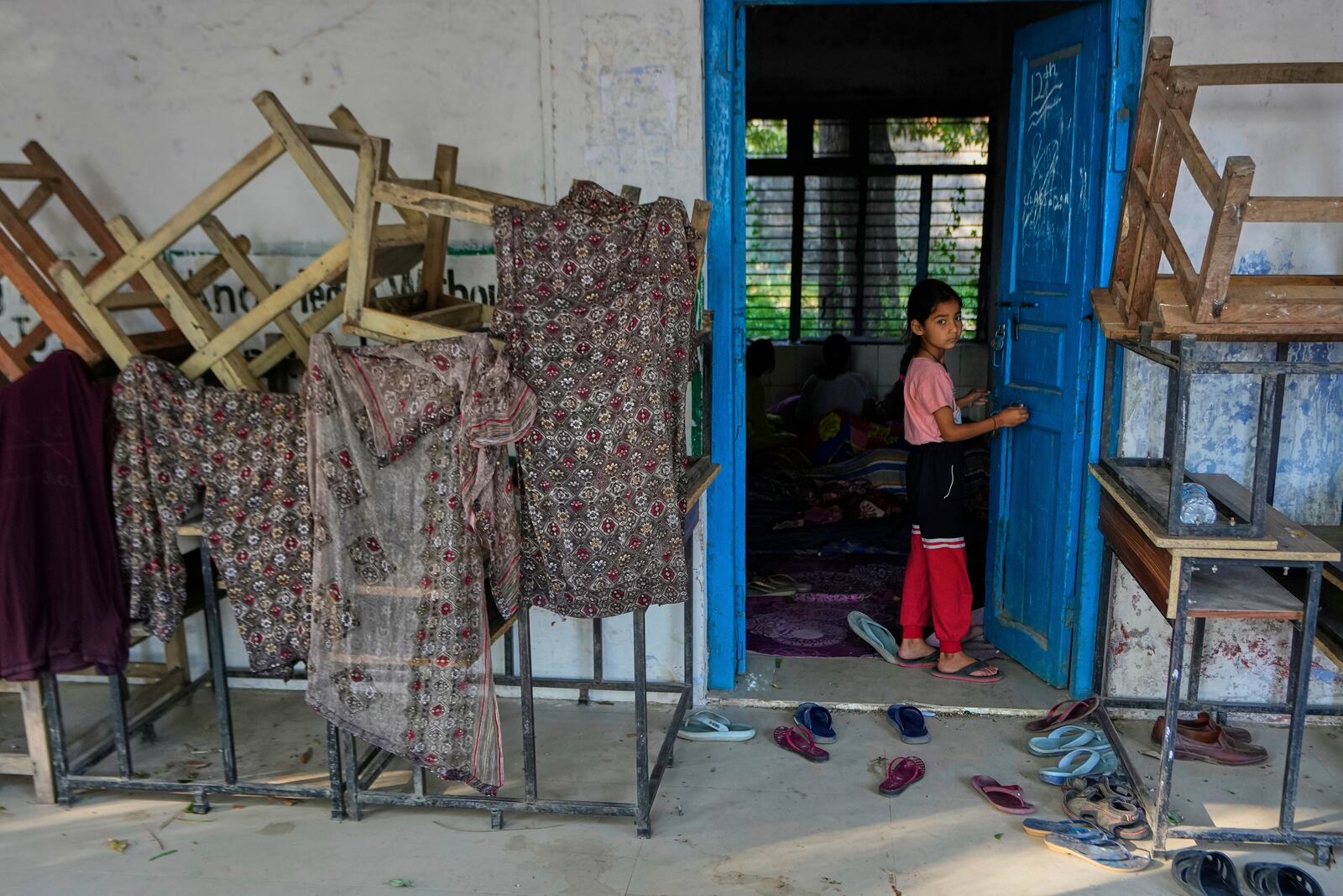 A girl evacuated from her village along the India Pakistan border takes refuge in a makeshift center in a school at RS Pura, along the International Border, India, Monday, May 12, 2025. (AP Photo/Channi Anand)