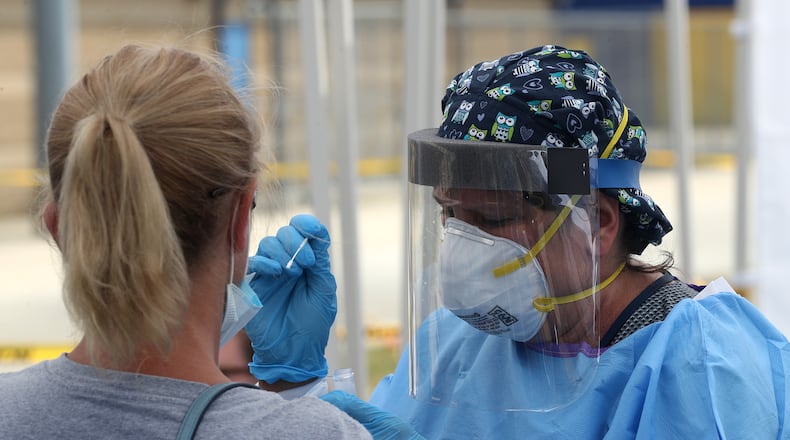 A woman gets a COVID-19 test on July 10, 2020 at the Clark County Combined Health District's free COVID testing clinic. BILL LACKEY/STAFF