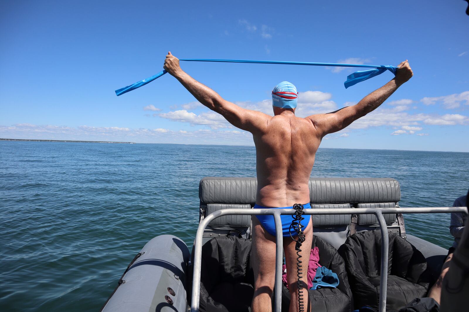 British South African endurance swimmer Lewis Pugh stretches before entering the water to complete his 12-day 62-mile (100 kilometer) swim around the island of Martha's Vineyard, Mass., ahead of the 50th anniversary of the first blockbuster film "Jaws"' release, Monday, May 26, 2025. (AP Photo/Leah Willingham)