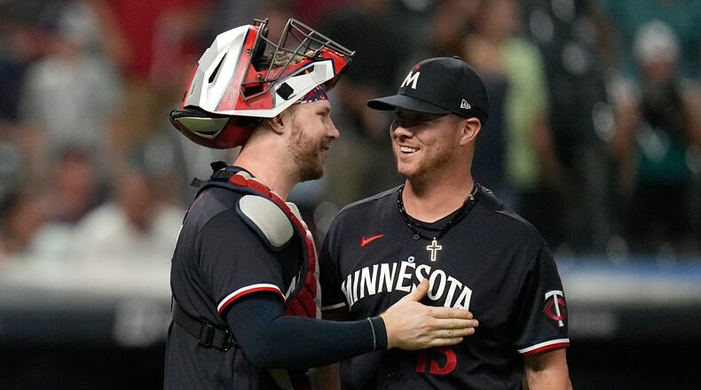 Minnesota Twins catcher Ryan Jeffers, left, and pitcher Emilio Pagán celebrate after the Twins defeated the Cleveland Guardians in a baseball game, Tuesday, Sept. 5, 2023, in Cleveland. (AP Photo/Sue Ogrocki)