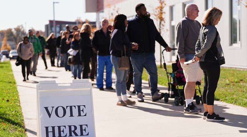 Voters wait in line to cast there ballot at a polling place at Rowan College in Mount Laurel, N.J., Monday, Oct. 27, 2025. (AP Photo/Matt Rourke)