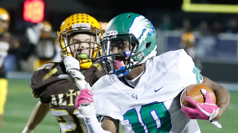Chaminade Julienne’s Dominic Wilcox runs for a first down while under pressure from Alter’s John Taylor last season at Fairmont. CJ won the Division III, Region 12 quarterfinal 49-28. BILL LACKEY/STAFF