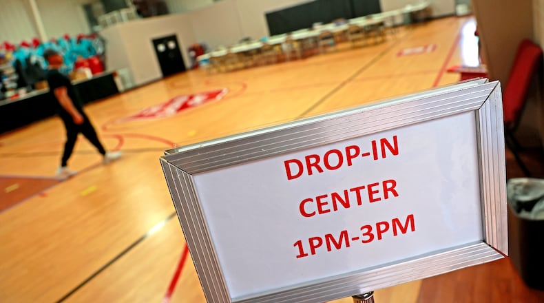 A sign at the entrance to the Salvation Army gymnasium lets people know the Drop-In Center is open from 1 p.m. to 3 p.m. Tuesdays and Thursdays. That program is one way to provide help to people experiencing homelessness who cannot stay at an emergency shelter now closing from 8 a.m. to 8 p.m. daily. BILL LACKEY/STAFF