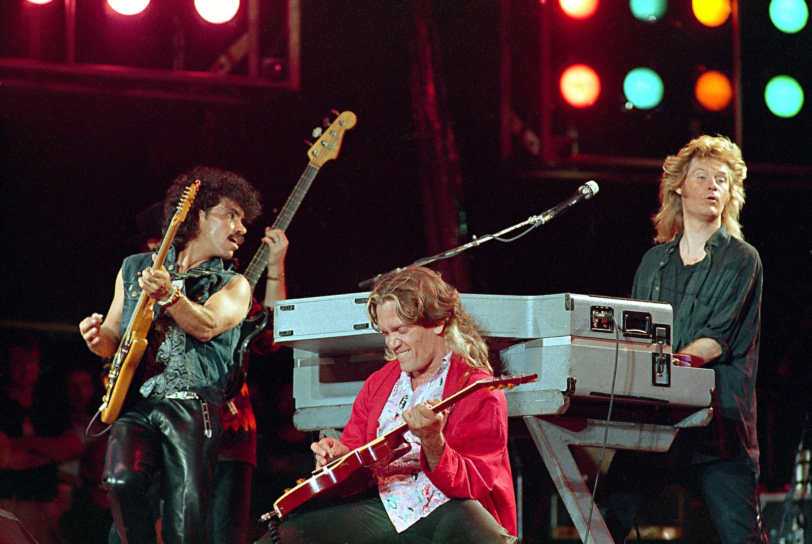 FILE - John Oates, from left, G.E.Smith and Daryl Hall perform at JFK Stadium in Philadelphia for the Live Aid famine relief concert on July 13, 1985. (AP Photo/Amy Sancetta, File)