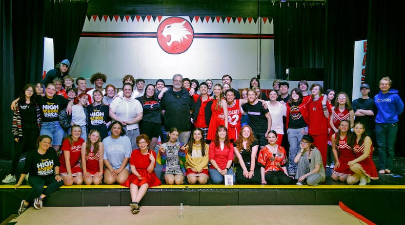 Director Bryan Szekacs and the cast of "High School Musical" Friday, April 19, 2024. This weekend's musical marks the 25th and last time Szekacs will direct the students in a performance. BILL LACKEY/STAFF