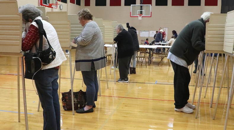 New Carlisle residents cast their ballots at Tecumseh High School Tuesday. BILL LACKEY/STAFF
