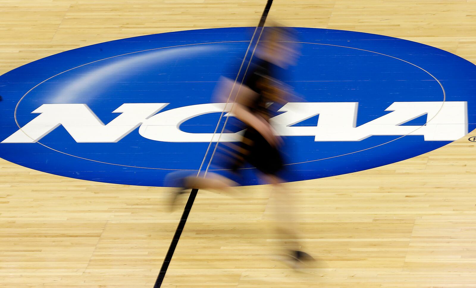FILE - In this photo taken with a slow shutter speed, Wichita State's Ron Baker runs during practice for the NCAA college basketball tournament, March 20, 2014, in St. Louis. (AP Photo/Charlie Riedel, file)