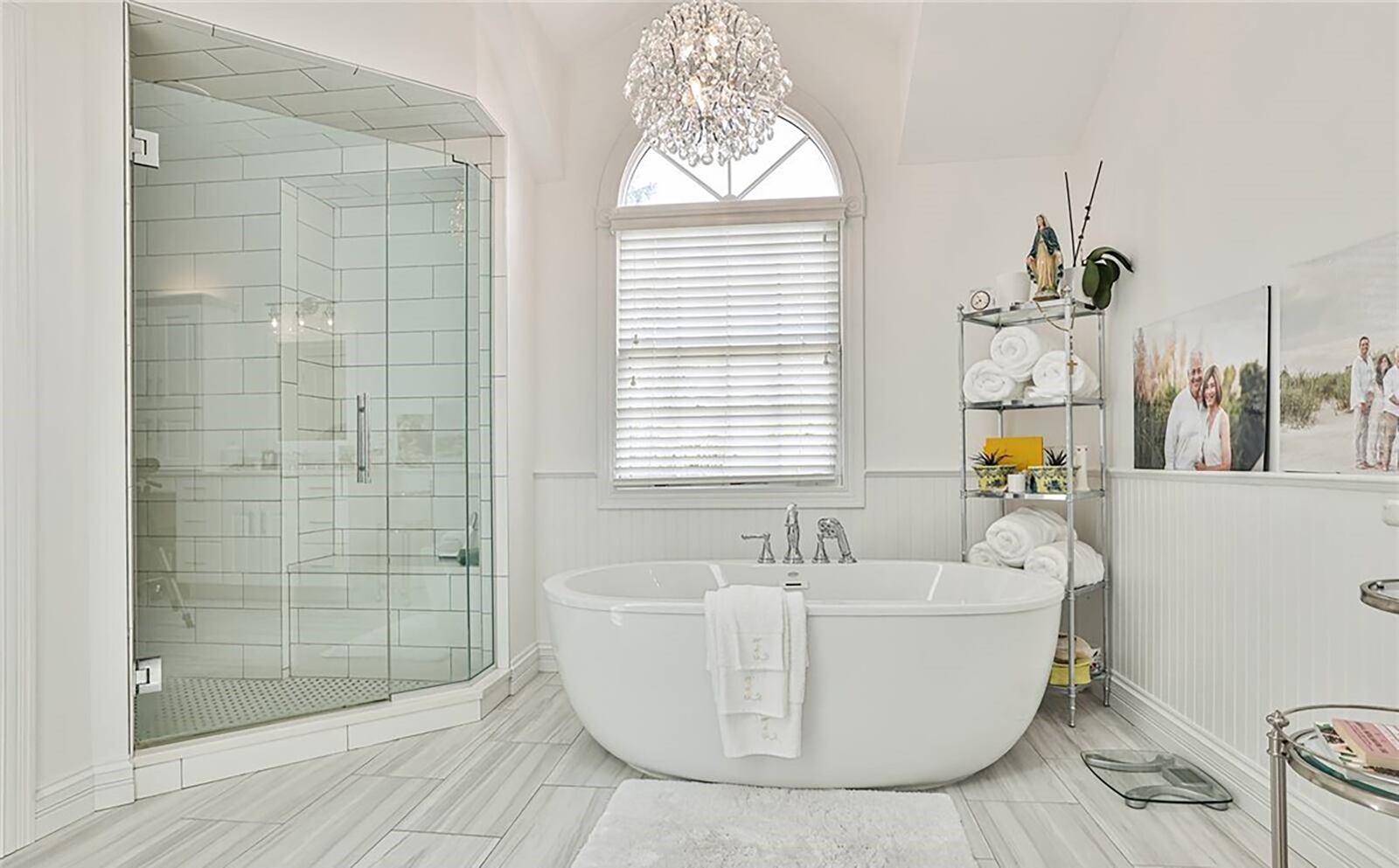 The primary ensuite bathroom has tile flooring, a freestanding bathtub and walk in shower and a skylight.