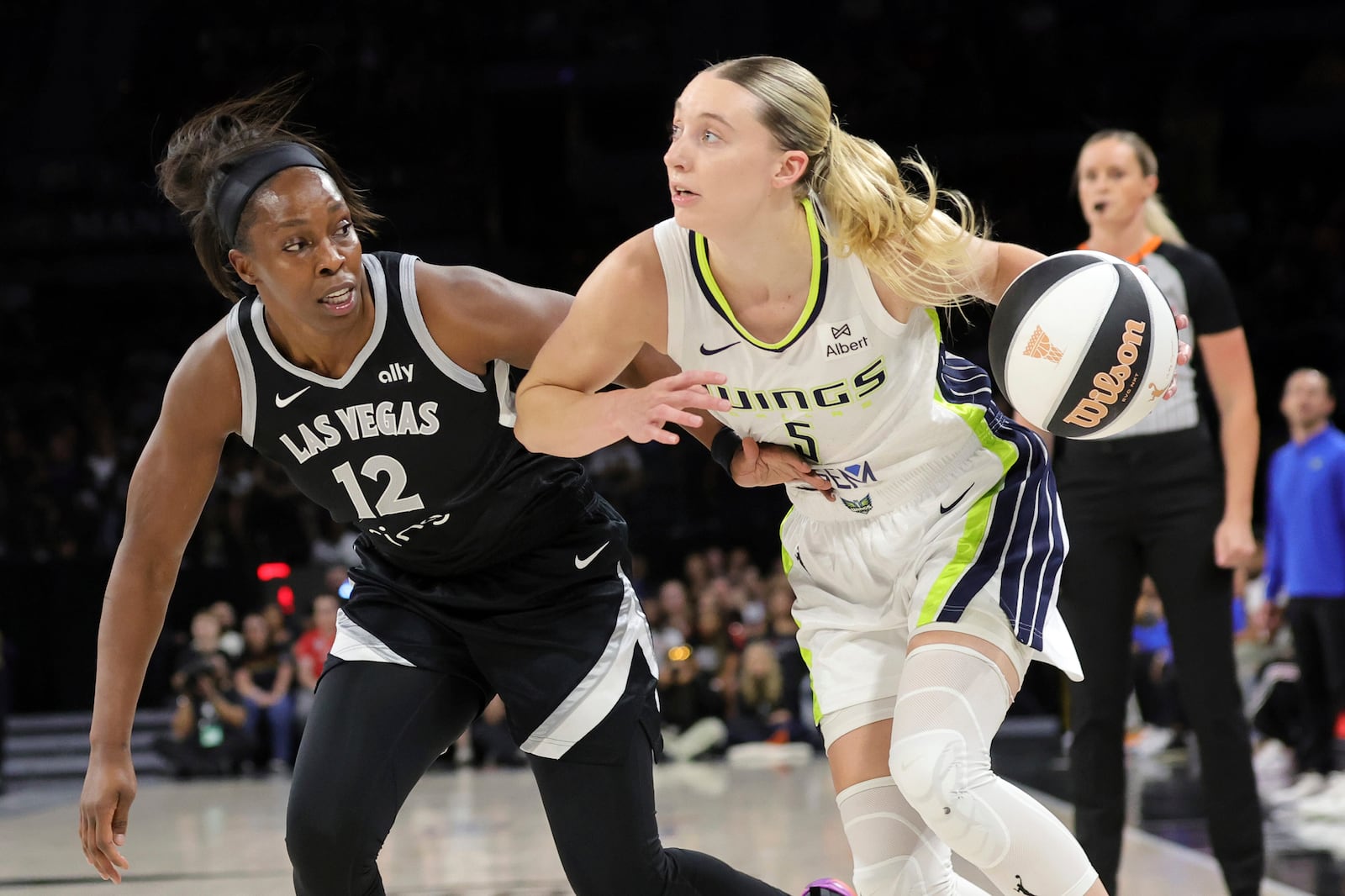 Dallas Wings guard Paige Bueckers (5) drives against Las Vegas Aces guard Chelsea Gray (12) during the first half of a WNBA basketball game Friday, June 13, 2025, in Las Vegas. (Steve Marcus/Las Vegas Sun via AP)
