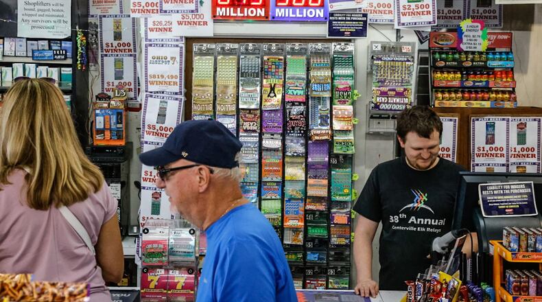 Bee-Gee's Mini Mart customer service expert, Quentin DeVelvis, right, has been printing-out Powerball tickets Thursday morning July 13, 2023. The Powerball is an estimated $875 million ahead of Saturday's drawing. JIM NOELKER/STAFF