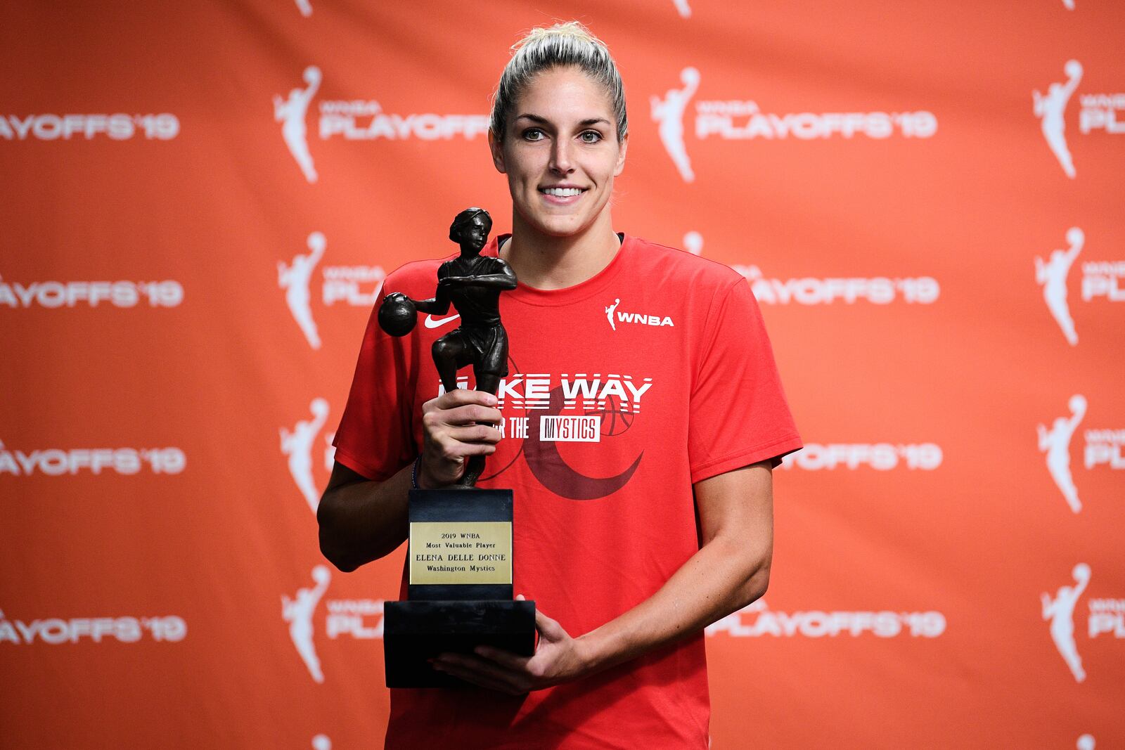 FILE - Washington Mystics forward Elena Delle Donne poses with the 2019 WNBA most valuable player trophy at a press conference, Thursday, Sept. 19, 2019, in Washington. (AP Photo/Nick Wass, File)