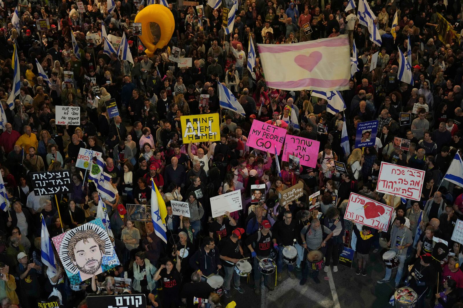 People take part in a protest demanding the immediate release of hostages held by Hamas in the Gaza Strip, in Tel Aviv, Israel, Saturday, April 5,2025. (AP Photo/Ariel Schalit)