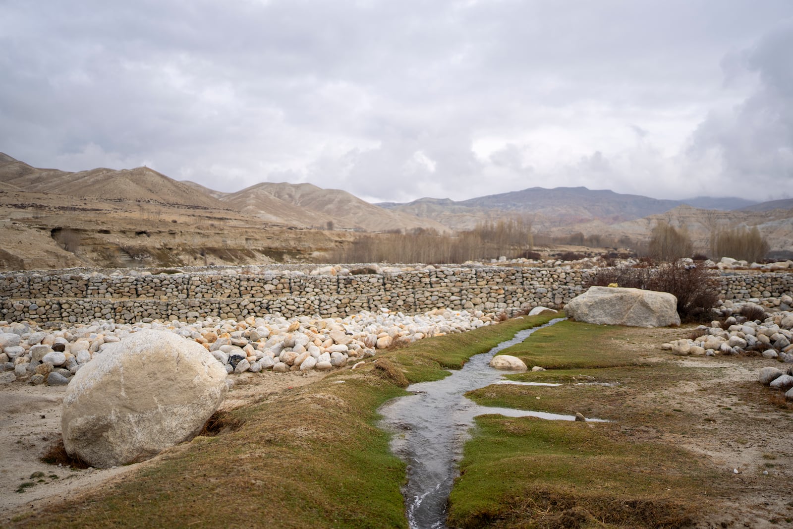 A stream which is the main source of drinking water flows through the newly relocated settlement of the abandoned Samjung village in the Mustang region, 462 kilometers west of Kathmandu, Nepal, Saturday, April 19, 2025. (AP Photo/Niranjan Shrestha)