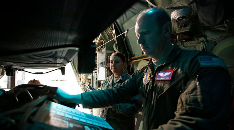 Flight nursing student Capt. Shauntel Haas, left, listens to flight nurse instructor Capt. Allen Potter as they train in the back of a C-130 Hercules at Wright-Patterson Air Force Base in early 2017. Military personnel at the base received aeromedical evacuation training with hands-on simulation techniques. TY GREENLEES / STAFF