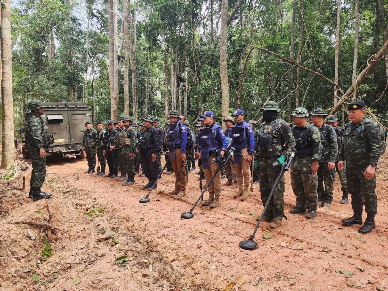 In this Sunday, July, 2025, photo released by the Royal Thai Army, Thai soldiers inspect a border area in Ubon Ratchathani†province where the Royal Thai Army said two anti-personnel landmines were found. (Royal Thai Army via AP)