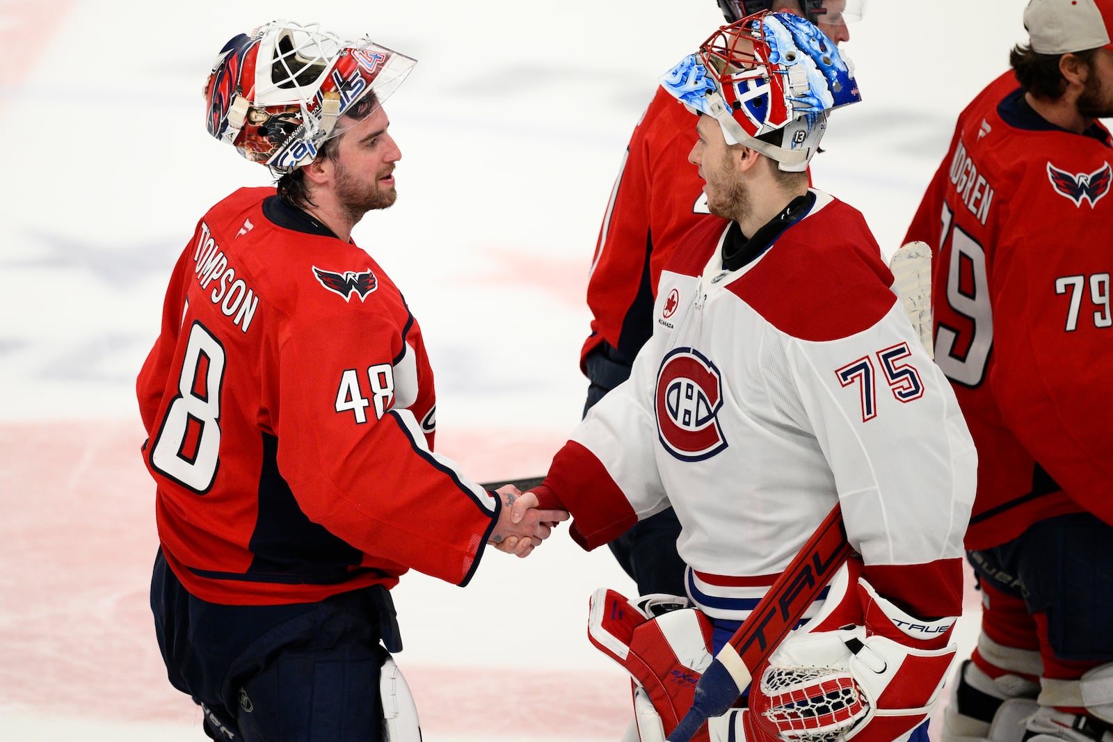 Washington Capitals goaltender Logan Thompson (48) shakes hands with Montreal Canadiens goaltender Jakub Dobes (75) after Game 5 of a first-round NHL hockey playoff series Wednesday, April 30, 2025, in Washington. (AP Photo/Nick Wass)