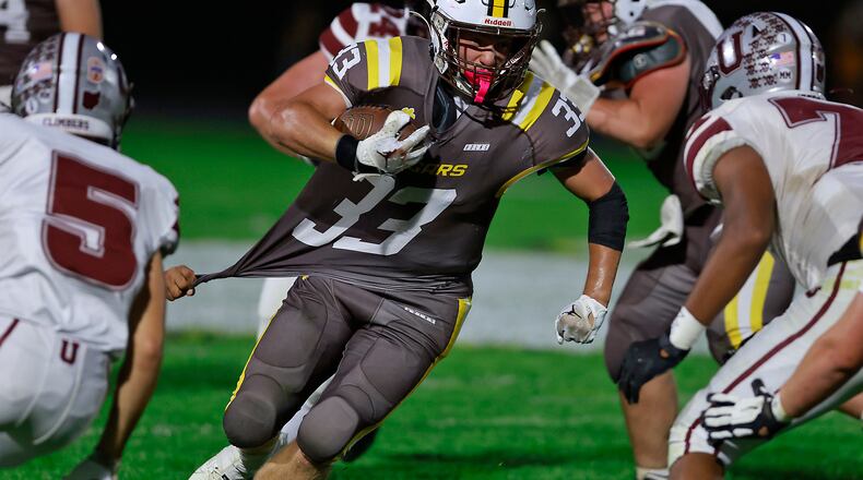 Kenton Ridge's Jackson Patton carries the ball vs. Urbana last week. The Cougars defeated Jonathan Alder on Friday night. BILL LACKEY/STAFF