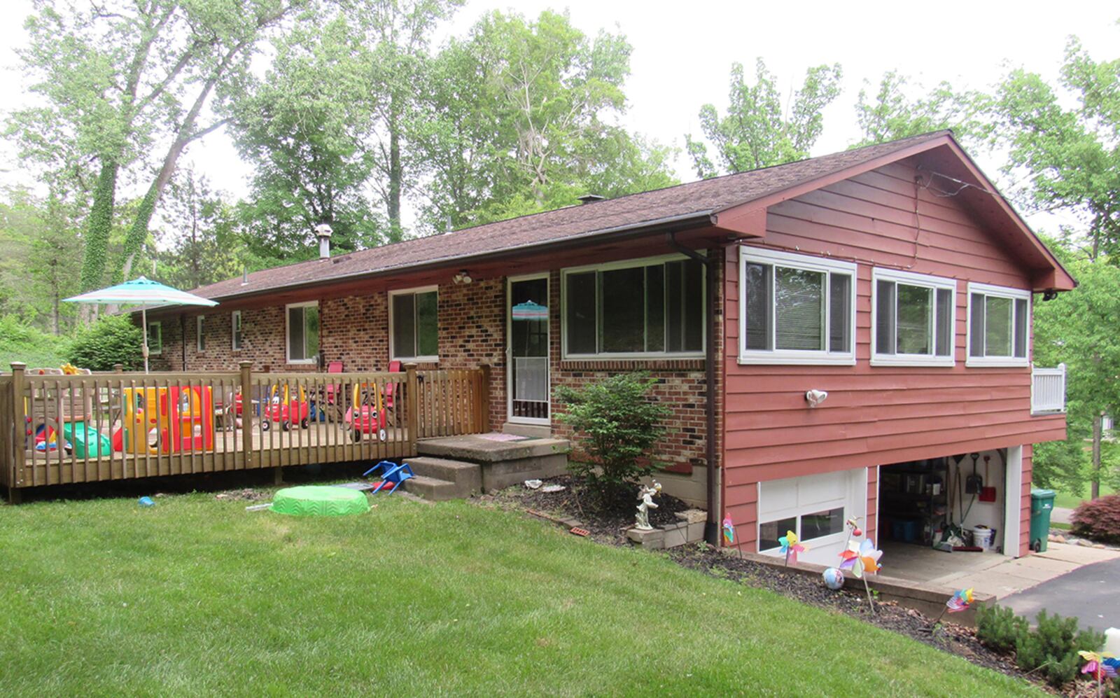 A newer, oversized wood deck is connected to the back of the home and overlooks the wooded back yard with many mature trees. CONTRIBUTED PHOTO