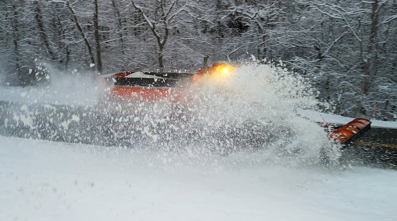 A plow clears Elk Creek Road after several inches of snow fell Tuesday, Dec. 2, 2025 in Madison Township in Butler County. NICK GRAHAM/STAFF