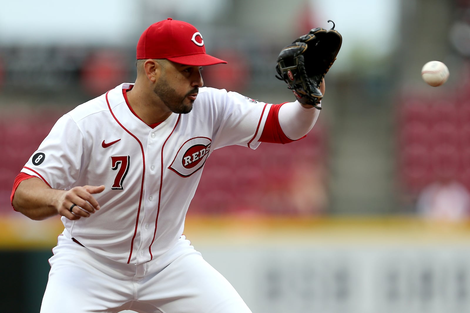Cincinnati Reds third baseman Eugenio Suarez (7) fields a ground ball by the St. Louis Cardinals in the first inning of a baseball game Monday, Aug. 30, 2021, in Cincinnati. (Kareem Elgazzar/The Cincinnati Enquirer via AP)
