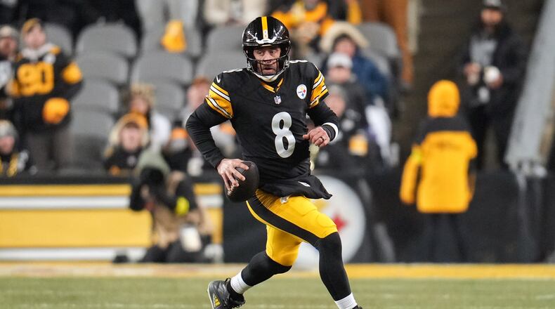 Pittsburgh Steelers quarterback Aaron Rodgers (8) runs with the ball during the first half of an NFL football game against the Baltimore Ravens, Sunday, Jan. 4, 2026, in Pittsburgh. (AP Photo/Gene J. Puskar)