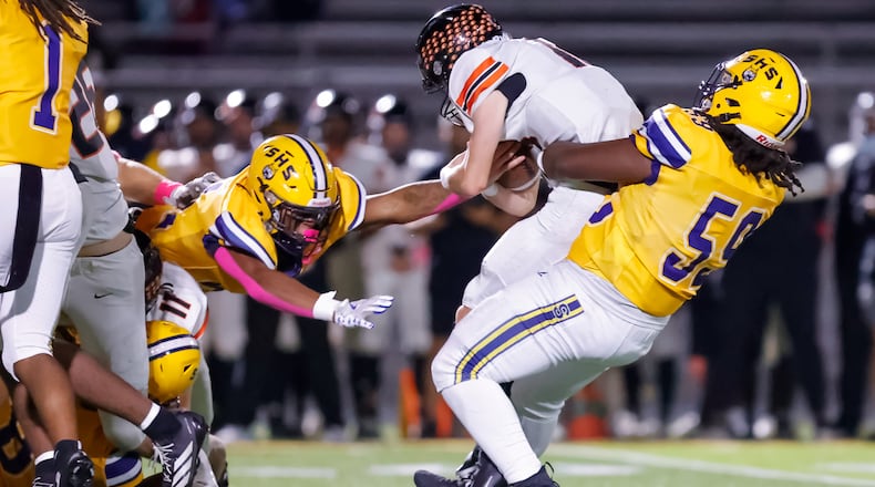 Springfield High School senior Royce Rogers tackles Beavercreek senior quarterback Jack Minnick during their 31-0 victory over the Beavers on Friday, Oct. 10 at Wildcat Stadium in Springfield. MICHAEL COOPER / STAFF