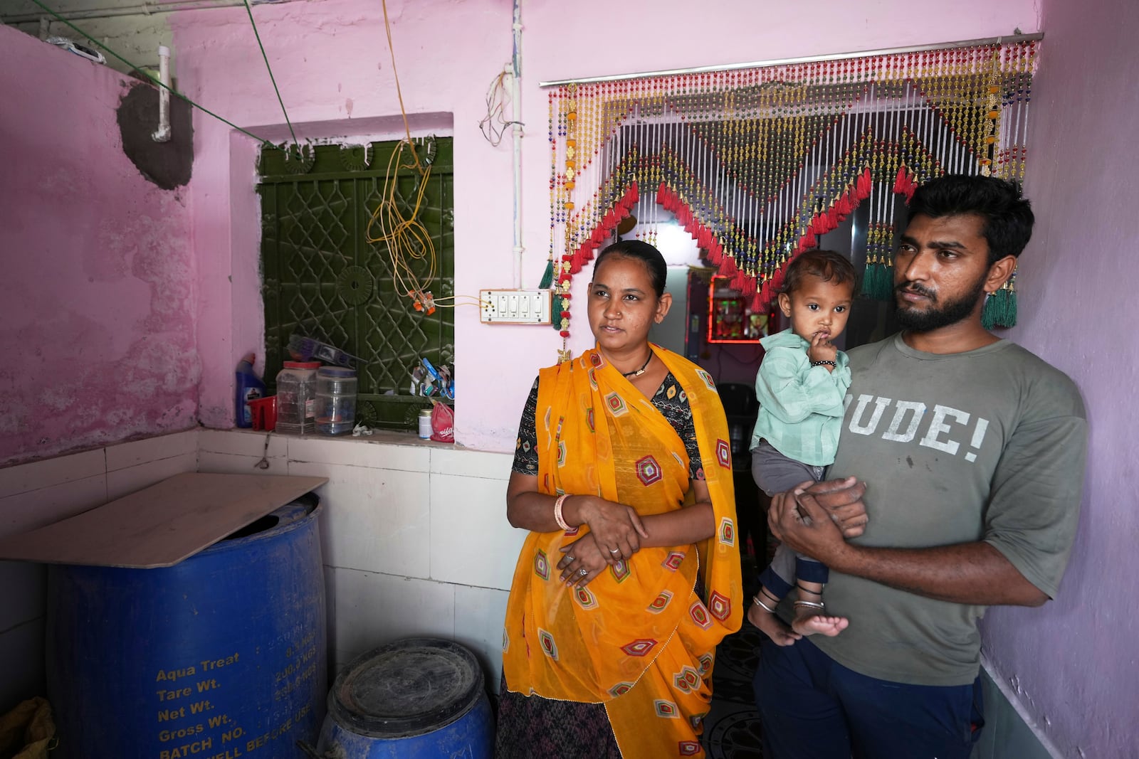 Akashbhai Thakor, right, and his wife Kumud stand at their house in Ahmedabad, India, Thursday, April 3, 2025. (AP Photo/Ajit Solanki)