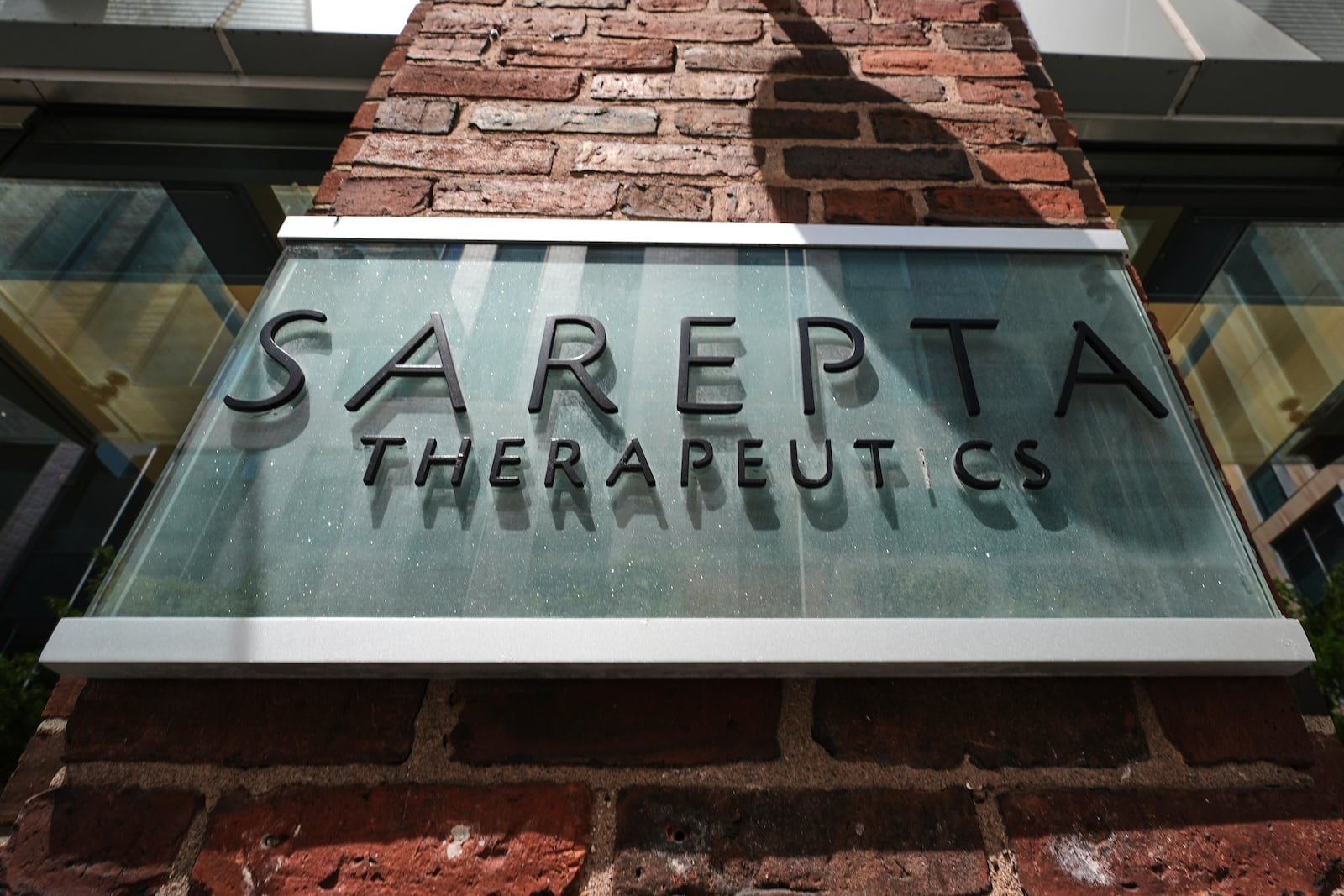 The name and logo of Sarepta Therapeutics is displayed on the company's headquarters, Monday, July 28, 2025, in Cambridge, Mass. (AP Photo/Charles Krupa)