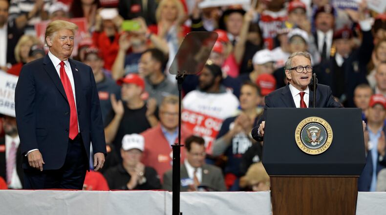President Donald Trump, listens, as Ohio gubernatorial winner Mike DeWine speaks at a campaign rally in Cleveland for the 2020 presidential campaign. (AP Photo/Tony Dejak)