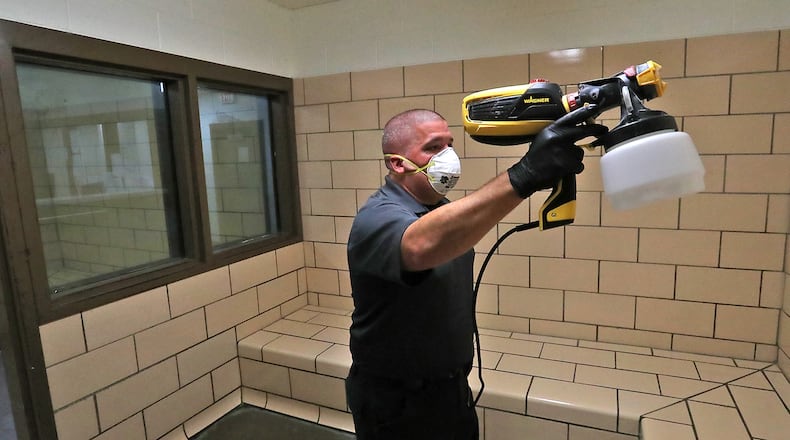 Deputy Shaun Lisle cleans a sanitizes a holding cell at the Clark County Jail Friday. BILL LACKEY/STAFF