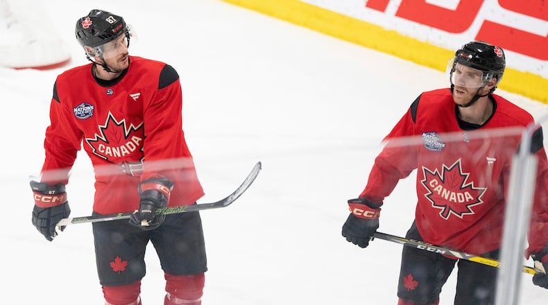 FILE - Canada's Sidney Crosby and Connor McDavid skate together following 4 Nations Face-Off hockey practice in Brossard, Quebec on Monday, Feb. 10, 2025. Canada will face Sweden on February 12. (Christinne Muschi/The Canadian Press via AP, File)