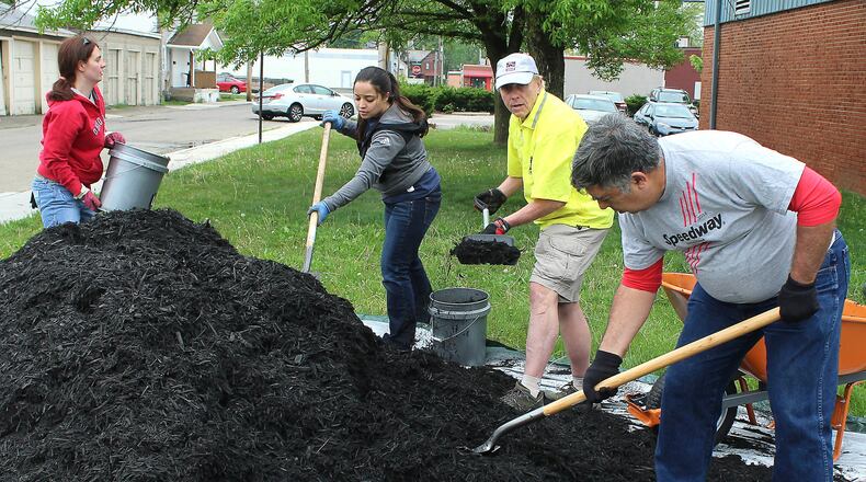 A group of workers from Speedway help with landscaping at the Salvation Army building in Springfield. Hundreds of people performed service projects across the Springfield community as part of the second Clark County Service Day in 2017.   FILE