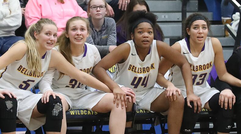 Members of the Bellbrook girls basketball team watch from the bench as a member of their team sinks a free throw to clinch the regional final victory over Tipp last Friday at Springfield. Bill Lackey/Staff