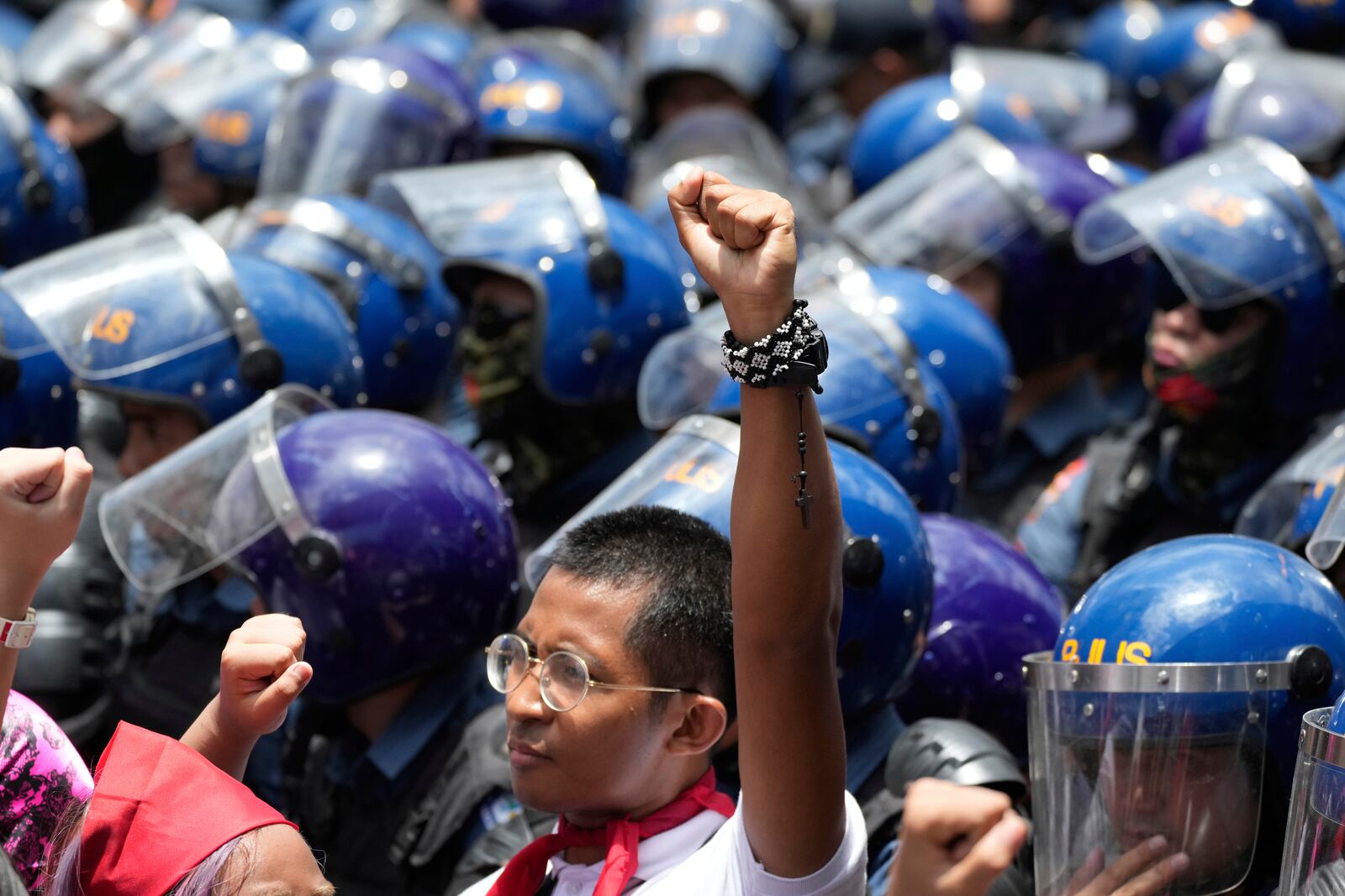 An activist raises his clenched fist during a May Day rally in Manila, Philippines, Thursday, May 1, 2025. (AP Photo/Aaron Favila)