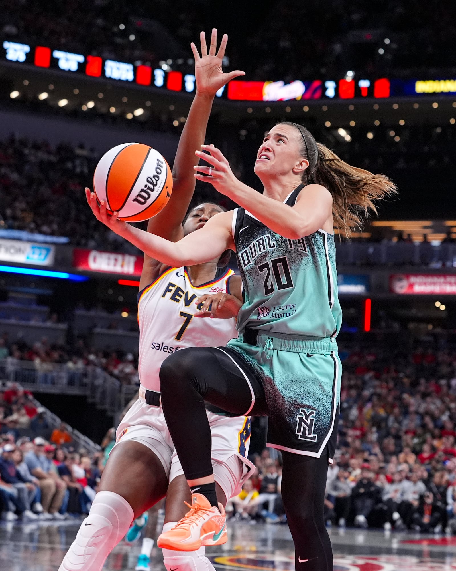 New York Liberty guard Sabrina Ionescu (20) shoots in front of Indiana Fever forward Aliyah Boston (7) in the first half of a WNBA basketball game in Indianapolis, Saturday, May 24, 2025. (AP Photo/Michael Conroy)