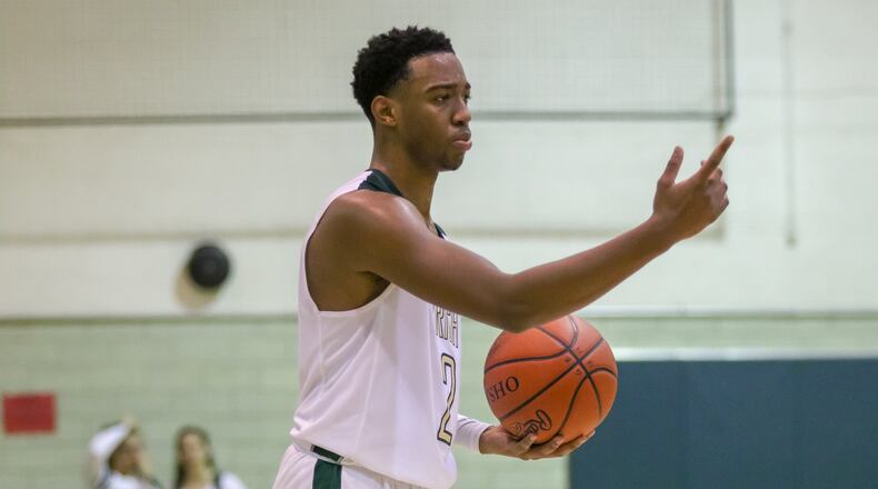 Catholic Central High School’s Sabien Doolittle directs his teammates during their game against Greenon earlier this season at Jason Collier Gymnasium in Springfield. Doolittle scored 21 points as the Irish won 73-43. CONTRIBUTED PHOTO BY MICHAEL COOPER